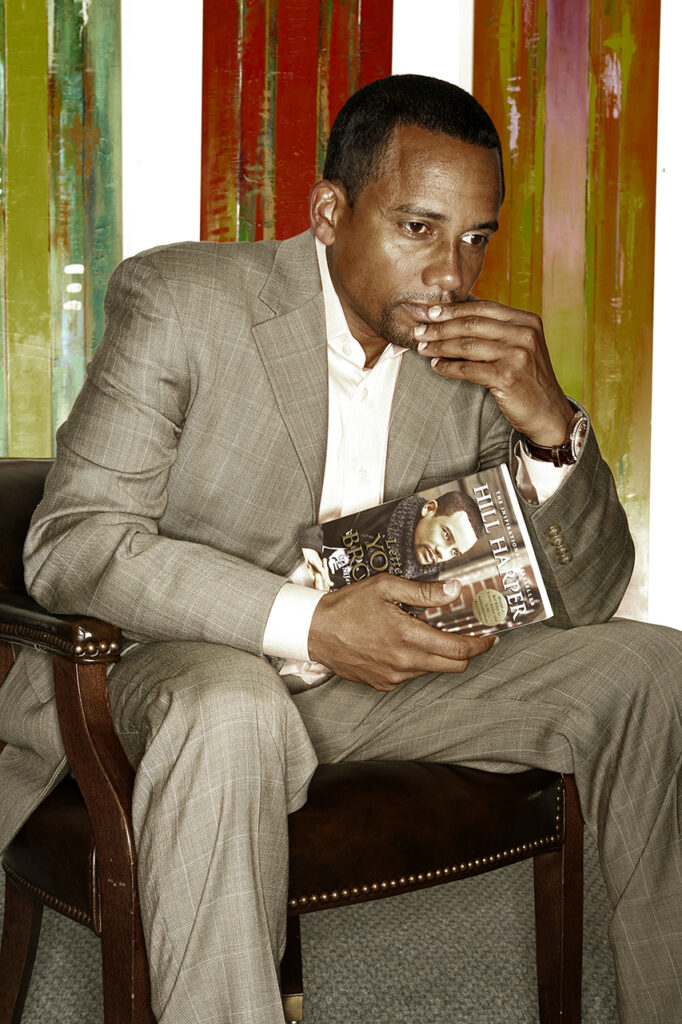 Hill Harper, award-winning actor and author, sitting thoughtfully with his book in hand, captured by Visionary Headshots.